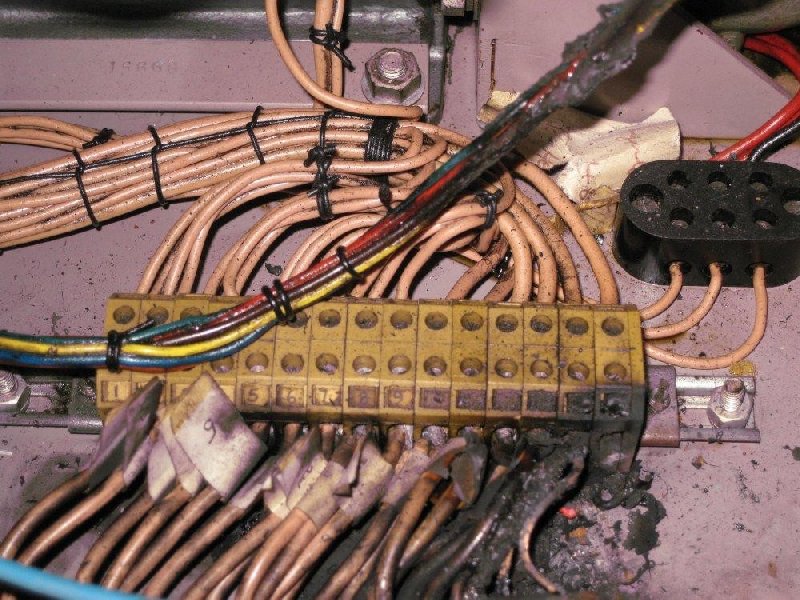 The terminal block showing charred wire insulation